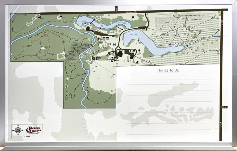 A framed site map whiteboard showing trails, lakes, buildings, and a blank Things To Do area on the right.